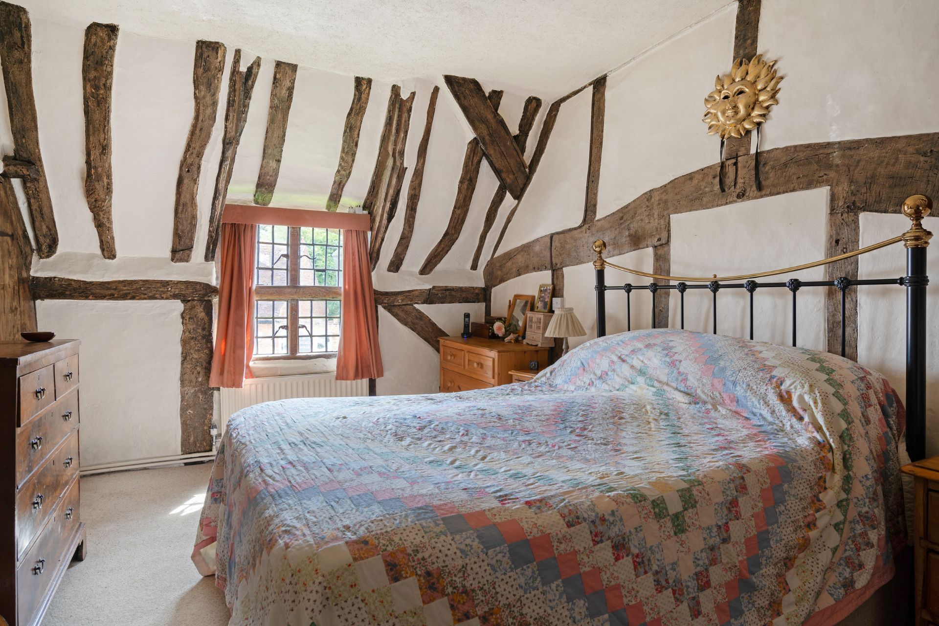 Cottage bedroom with exposed beams and leaded windows