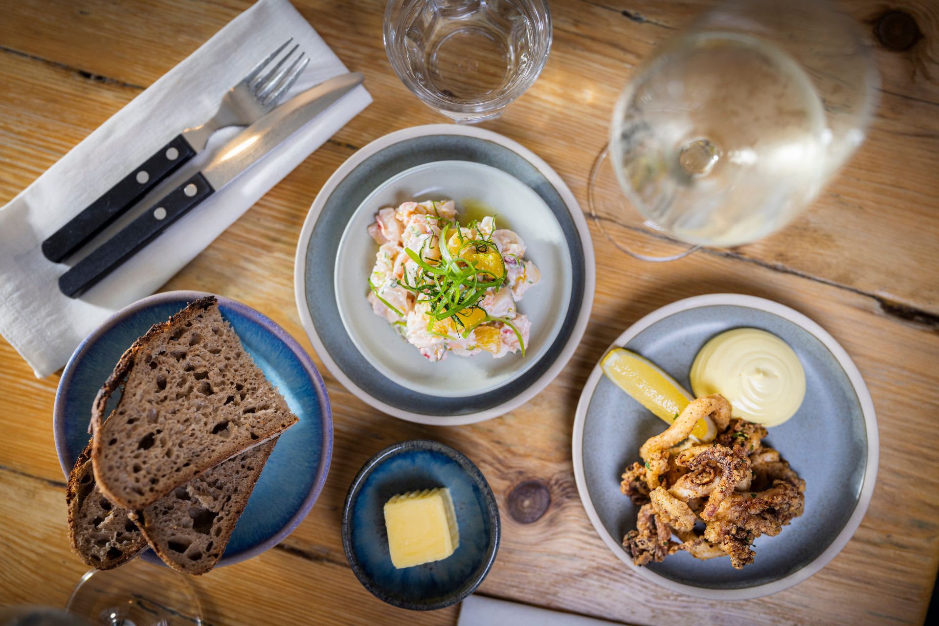 Aerial shot of seafood dishes and sourdough bread