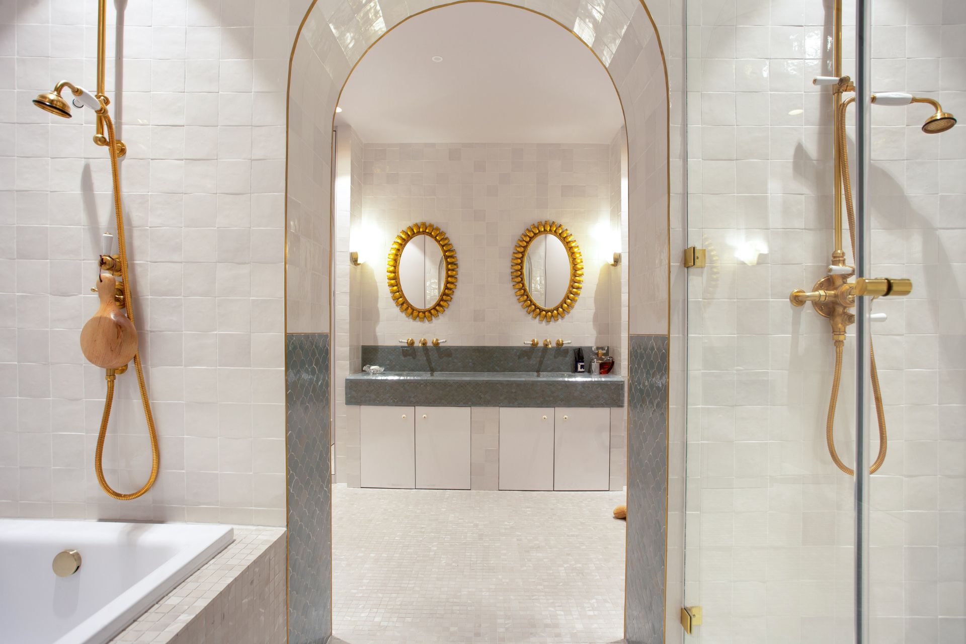 Bathroom with arched doorways and gold fixtures