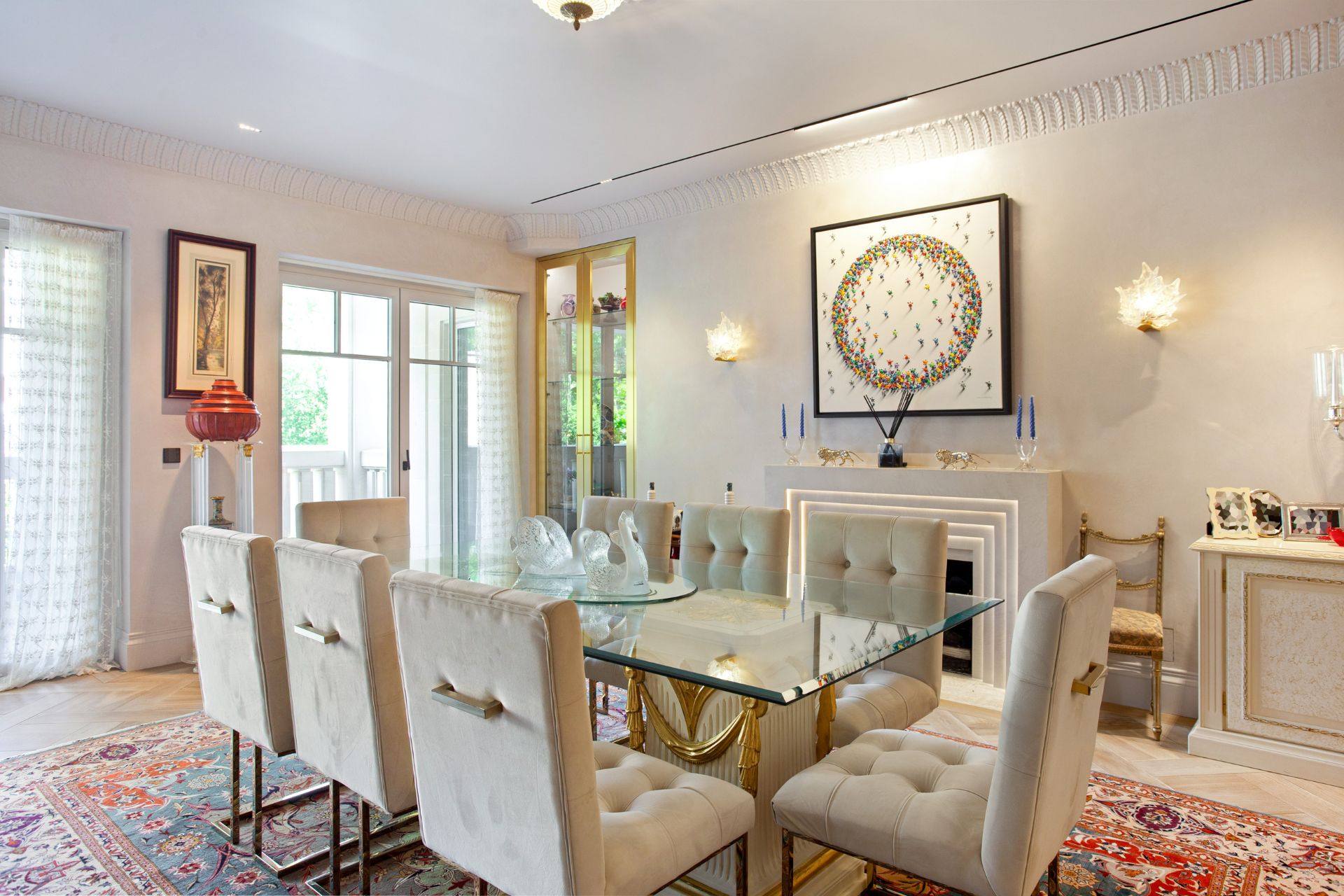 Dining area with glass table and white chairs