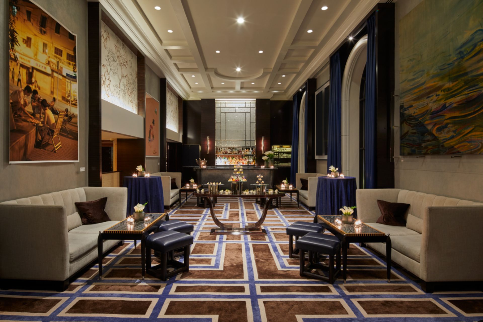 Hotel lounge with navy chairs and arched windows