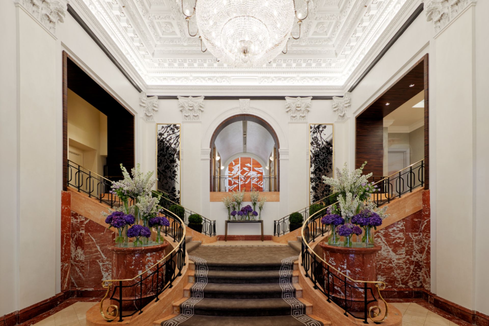 Lobby with central staircase and large crystal chandelier