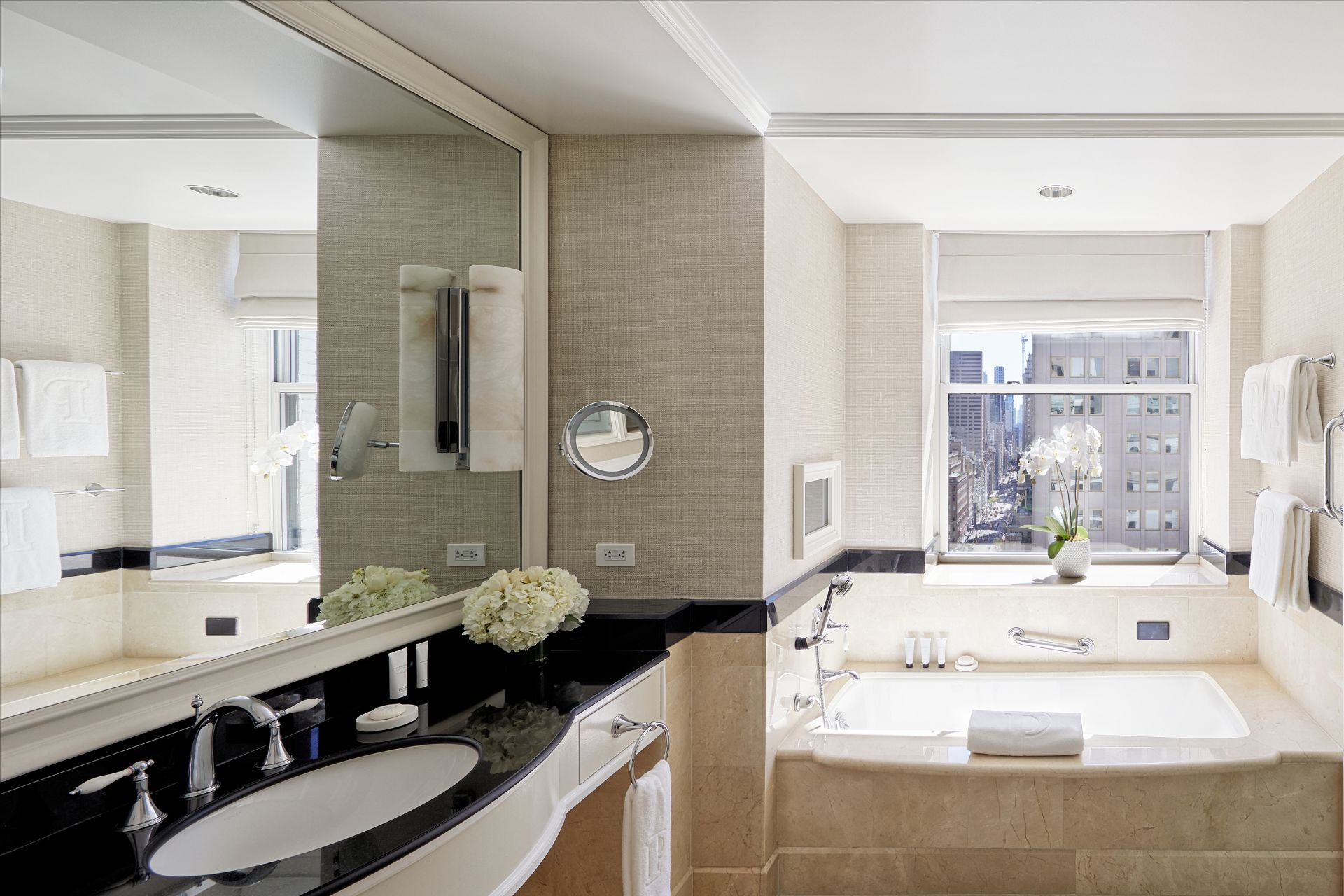 Hotel bathroom with marble bath and New York views