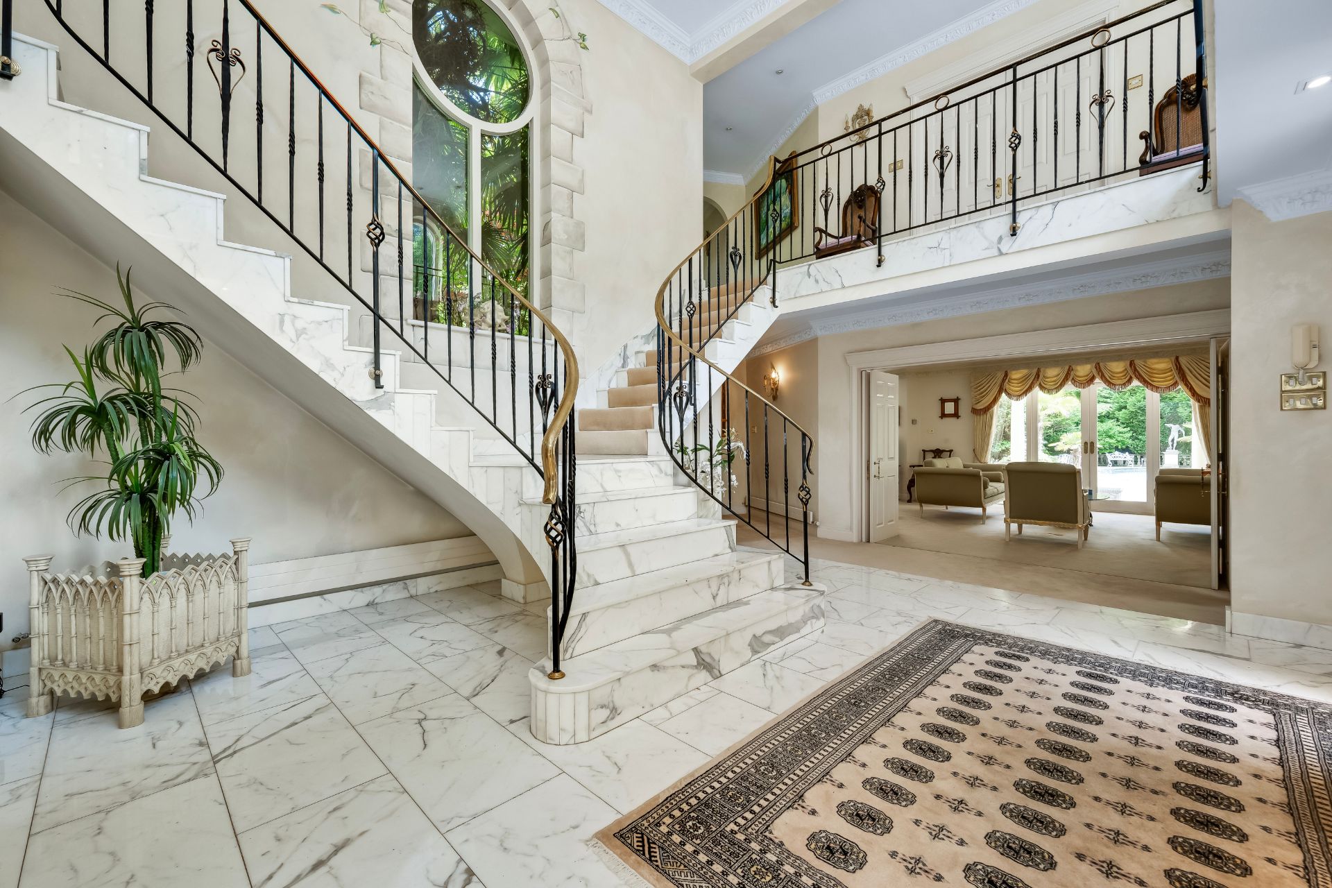 Marble tiled hallway with grand staircase