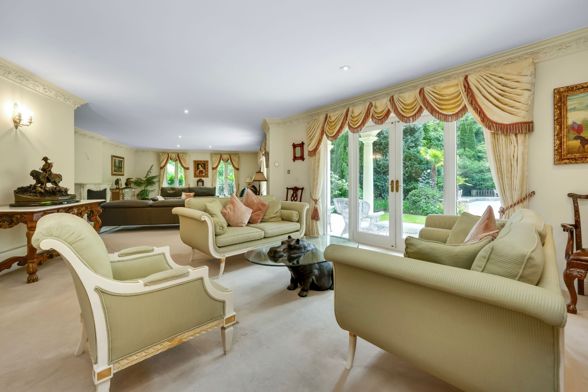 Sitting room with cream sofas and French doors