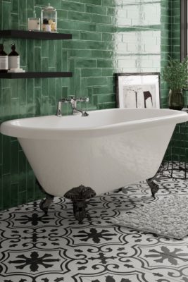 Dark green tiled bathroom with claw-foot bathtub and black and white tiles