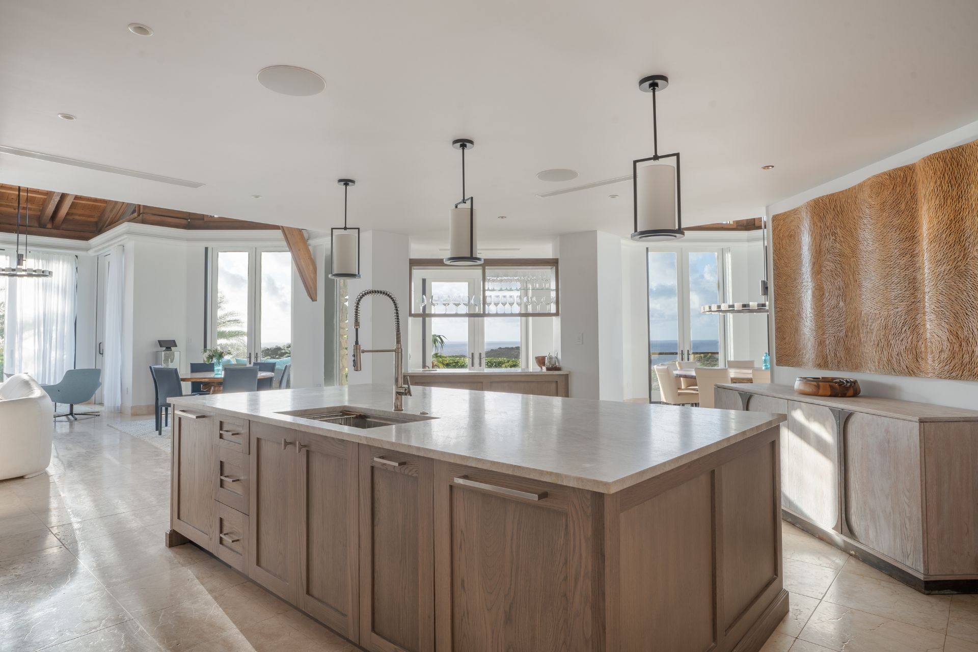 Larg kitchen with pale wooden cabinets and white worktops