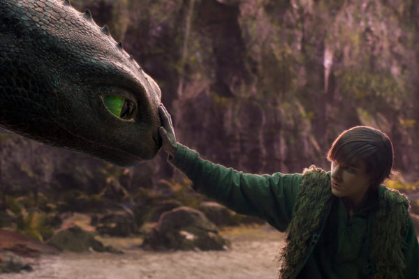 Mason Thames (right) as Hiccup with his Night Fury dragon, Toothless, in Universal Pictures’ live-action How to Train Your Dragon, written and directed by Dean DeBlois.
