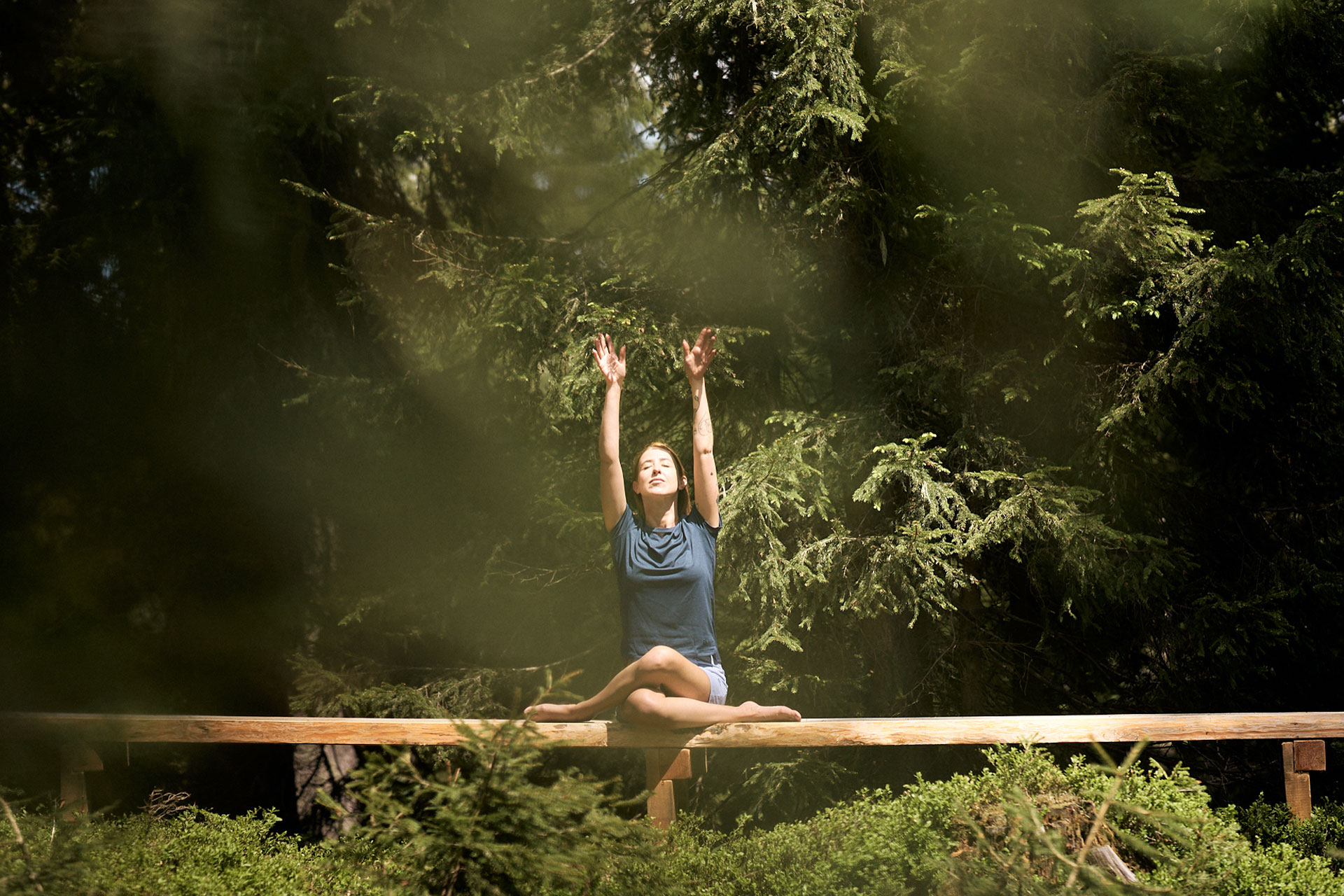 A woman meditating in a forest