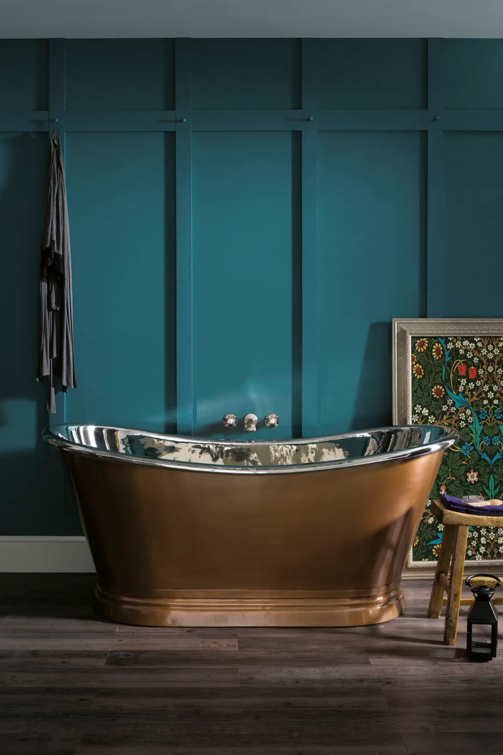 Copper bathtub with blue wall behind