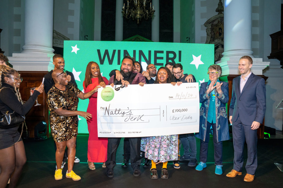 The founders of Natty's Jerk Chicken winning an award