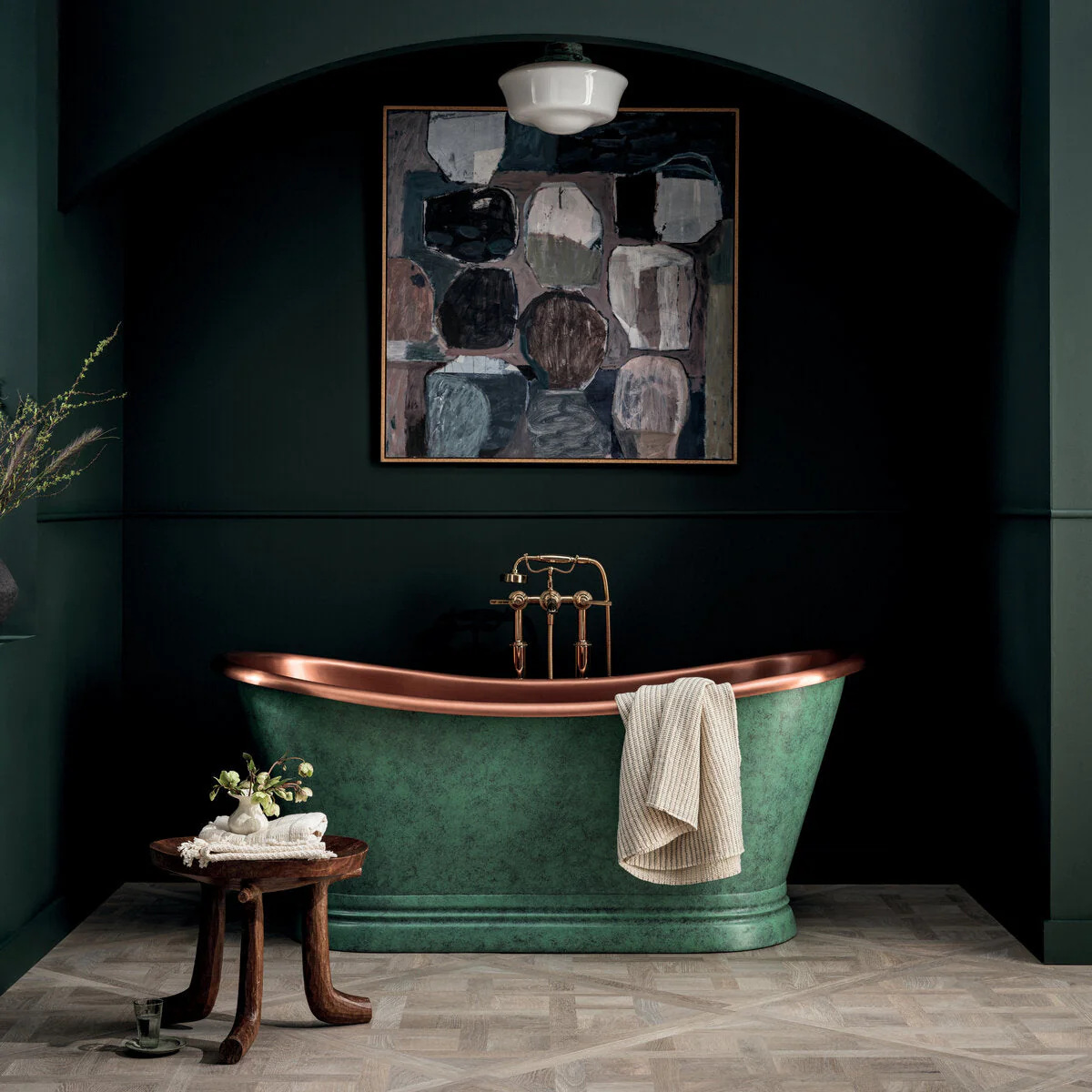 Blue bathtub with dark green wall behind