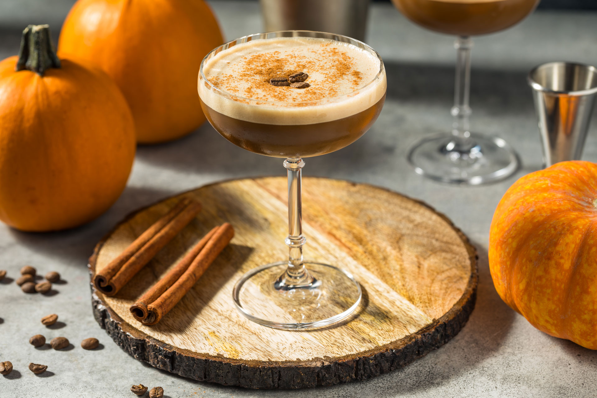 Pumpkin spice espresso martini with pumpkins in the background