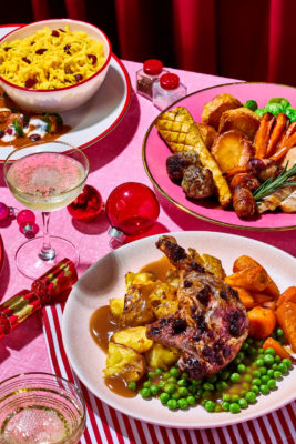 A plate of Christmas food with a pink background