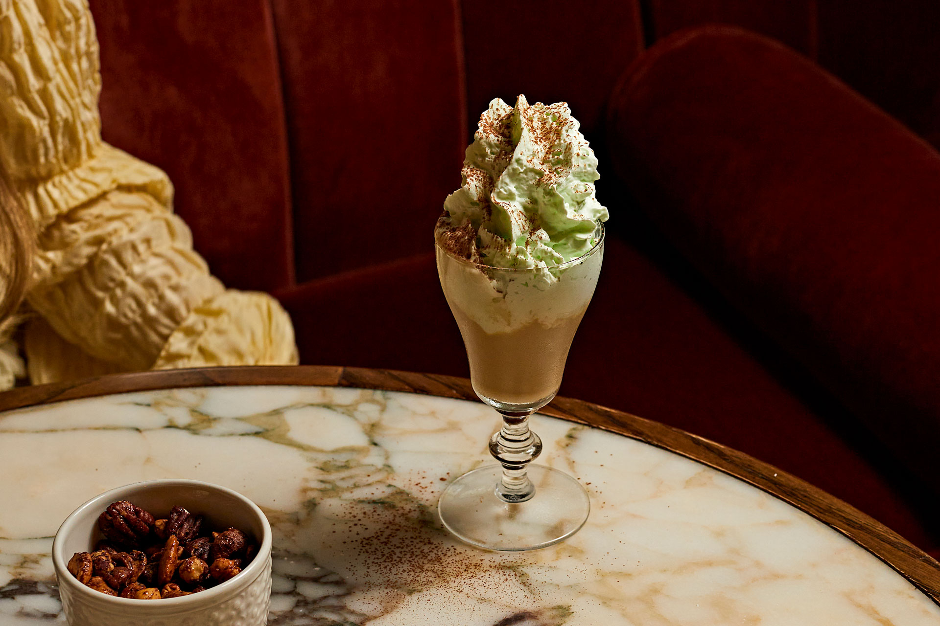 Chocolate cocktail with some nuts on a table