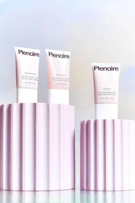 Skincare products on pink tiers