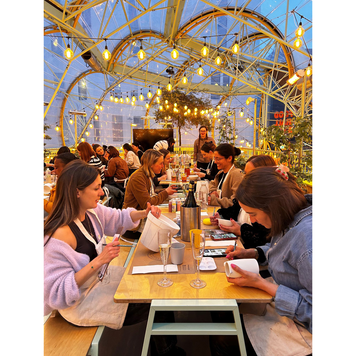 A group of people painting pottery