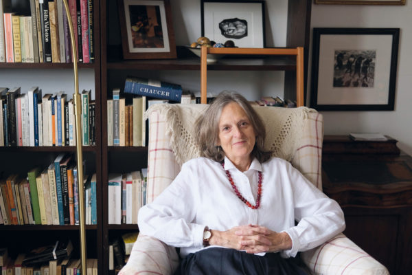 Tessa Hadley on an armchair in front of a bookshelf