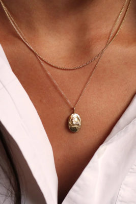 Close up of neck with gold jewellery