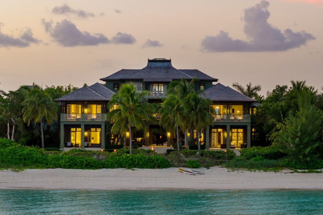 Exterior of contemporary Bahamas beachfront villa at sunset