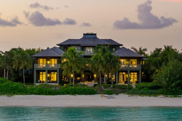 Exterior of contemporary Bahamas beachfront villa at sunset