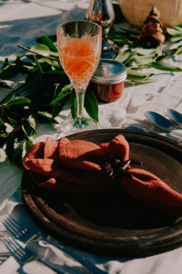 Thanksgiving table setting with an orange cocktail