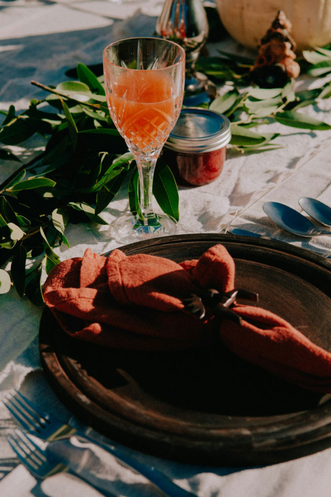 Thanksgiving table setting with an orange cocktail