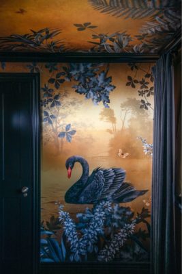 Gold an navy ceiling mural depicting floral designs and a navy swan