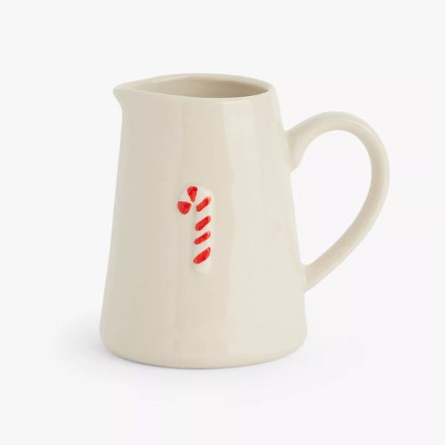 Cream ceramic jug with a central candy cane motif