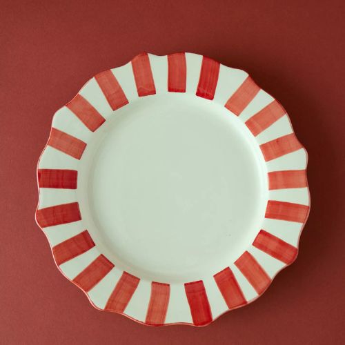 White dinner plate with a red and white striped edge