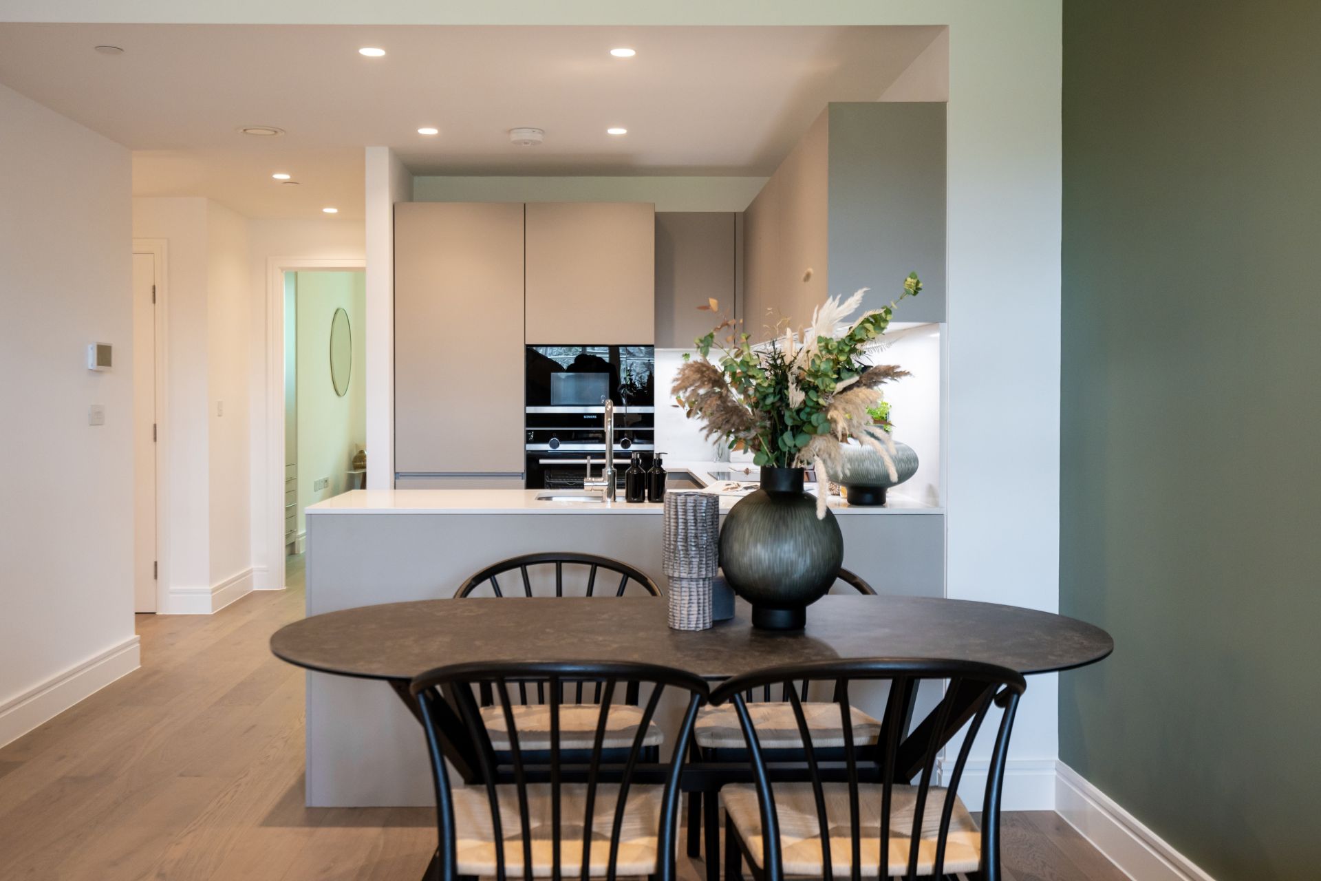 Modern litchen with curved dark wooden dining table