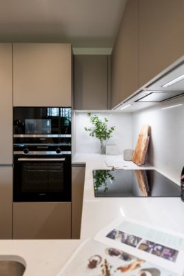 Modern litchen with taupe cabinets and white countertops