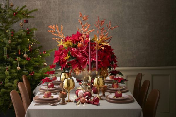 Christmas table with a poinsetta centrepiece