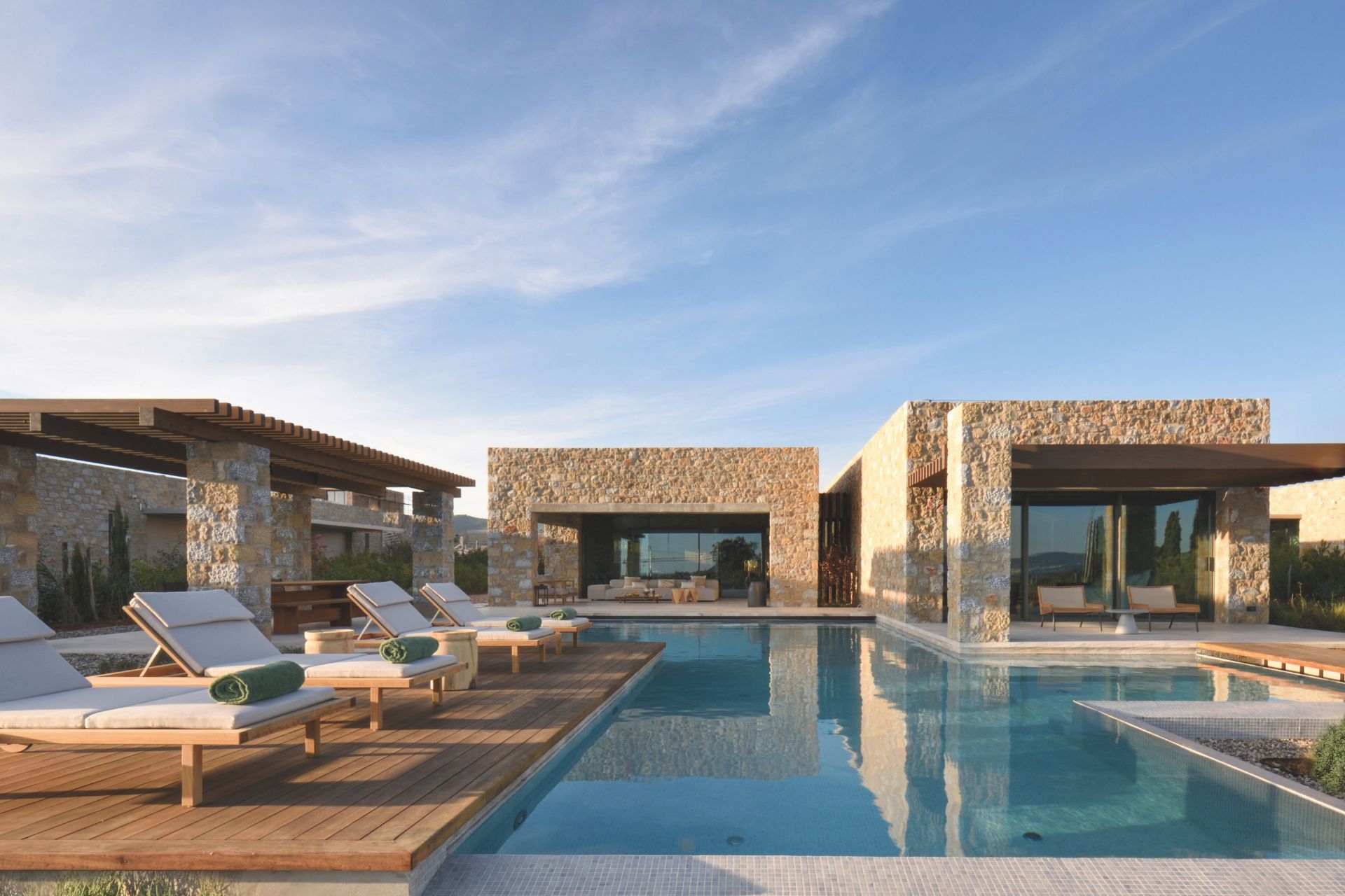 Modern stone villa with infinity pool and wooden sun deck