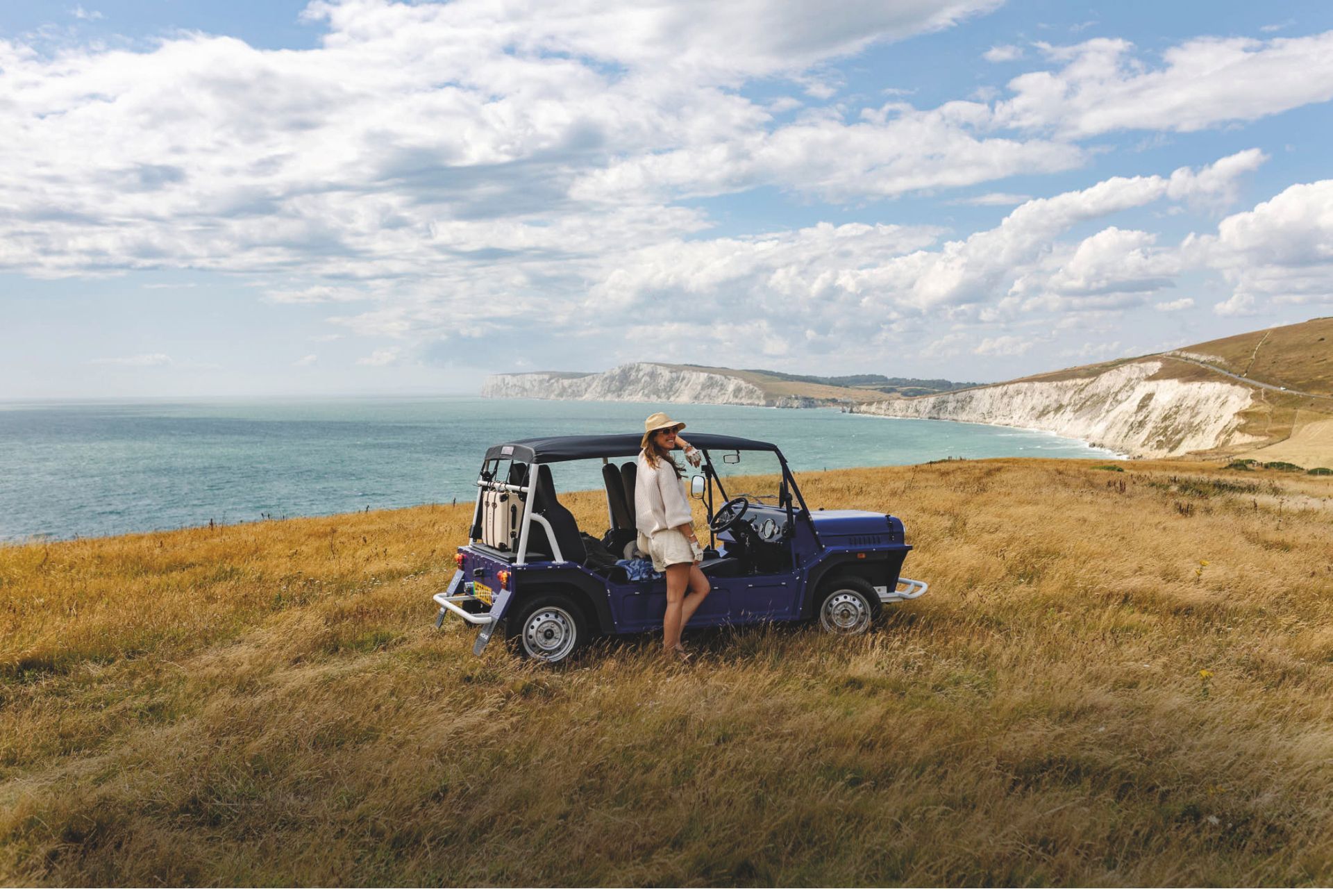 Fee Drummond leaning on a Land Rover on a cliff