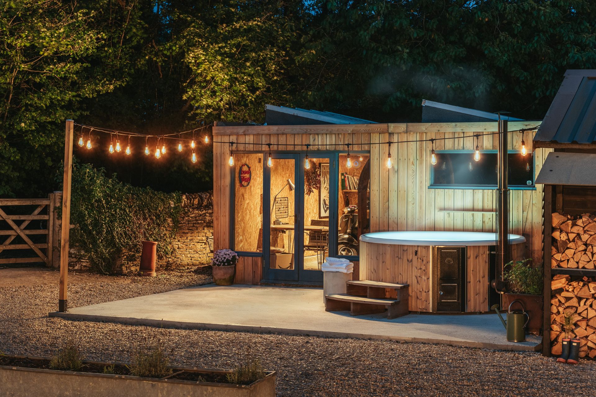 Garden at night with outdoor hot tub and fairy lights