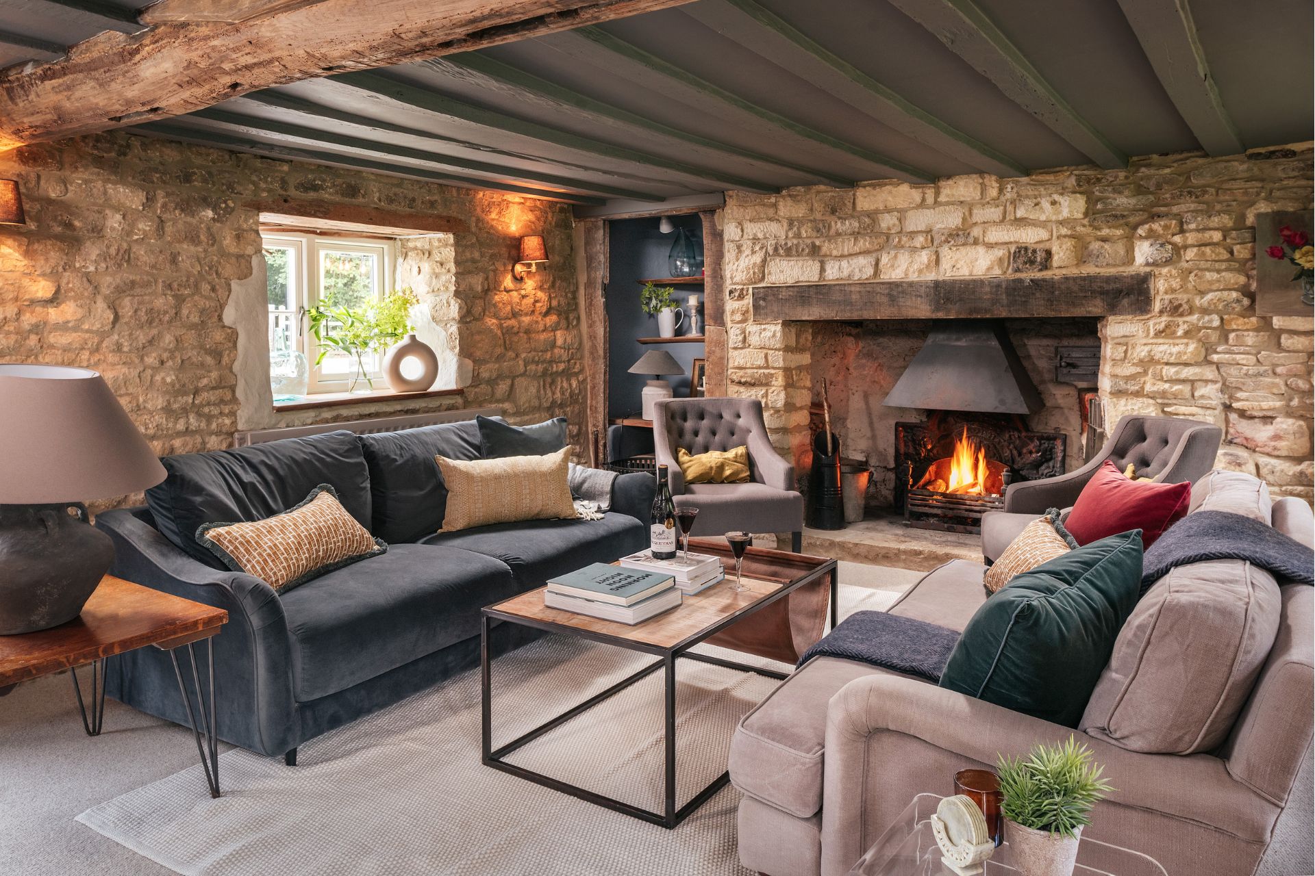 Cottage living room with fireplace and low timber ceilings