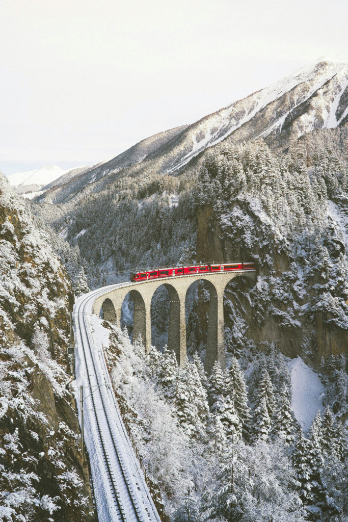 A train on a snowy aqueduct