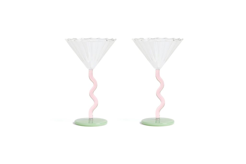 Martini glasses with wavy pink stems and pale green bases.