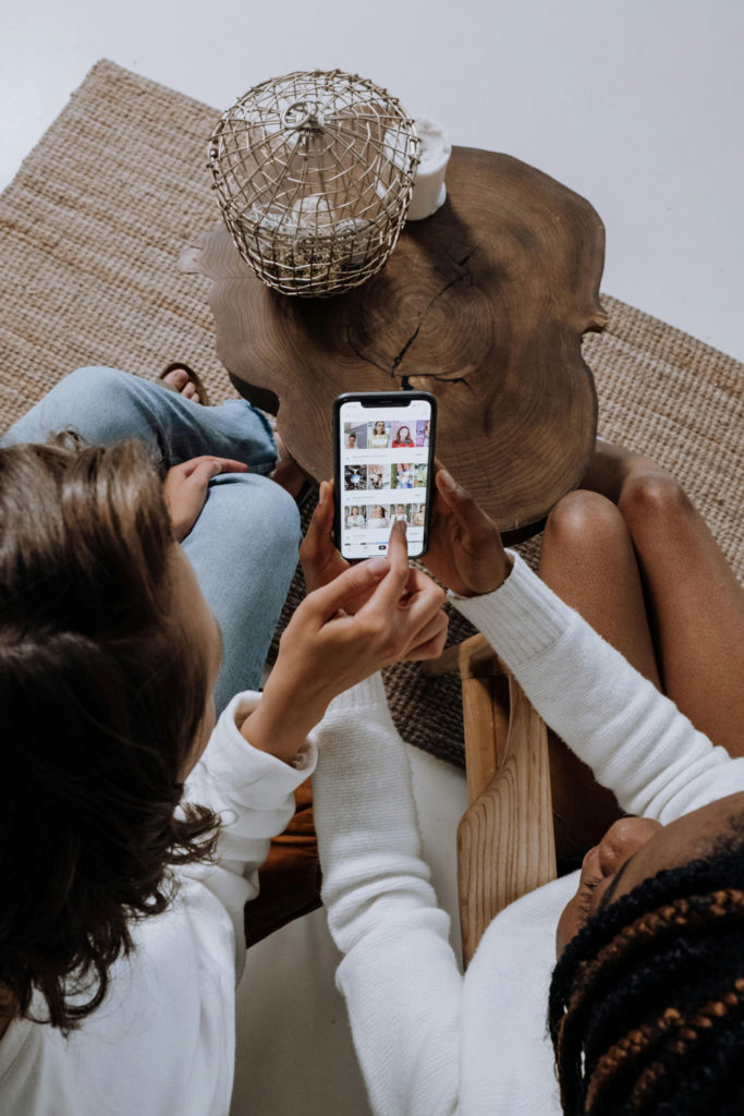 Two women looking at a mobile phone