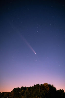 A shooting star in a dusk sky