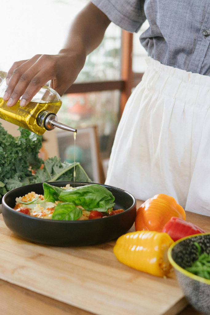 Woman cooking with oil and peppers