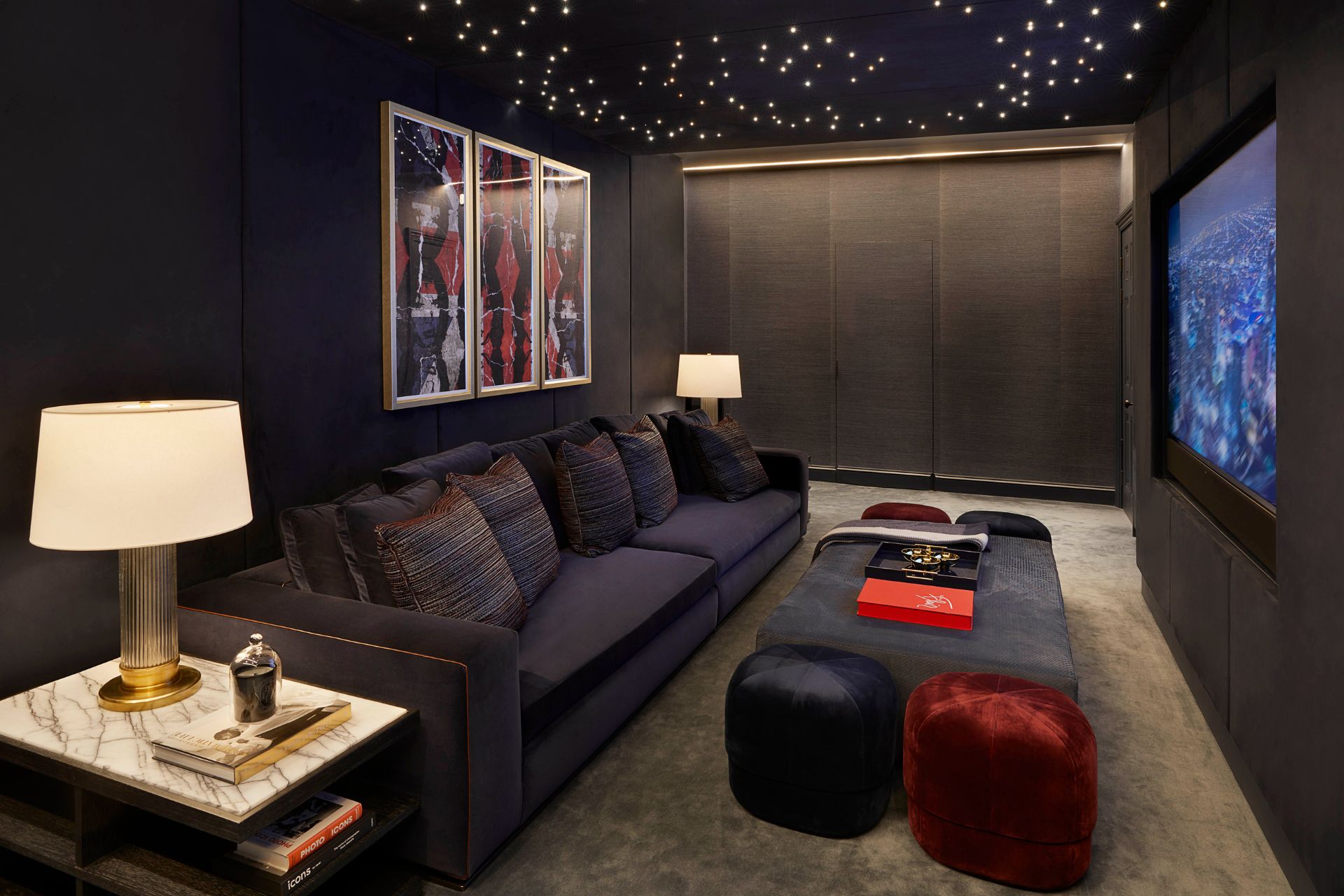 Home cinema with navy walls and velvet sofas