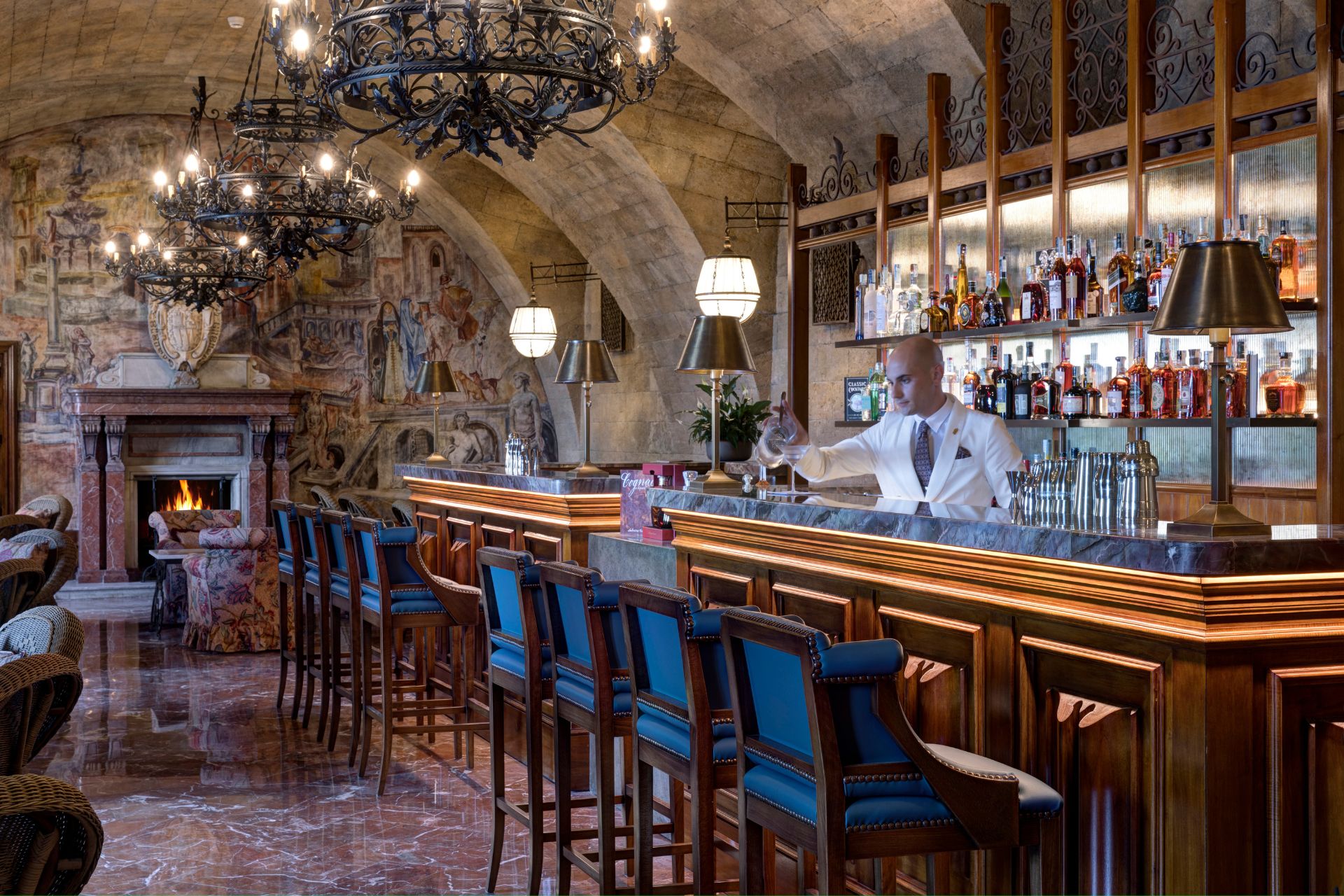 Bar with vaulted stone ceilings and blue velvet chairs