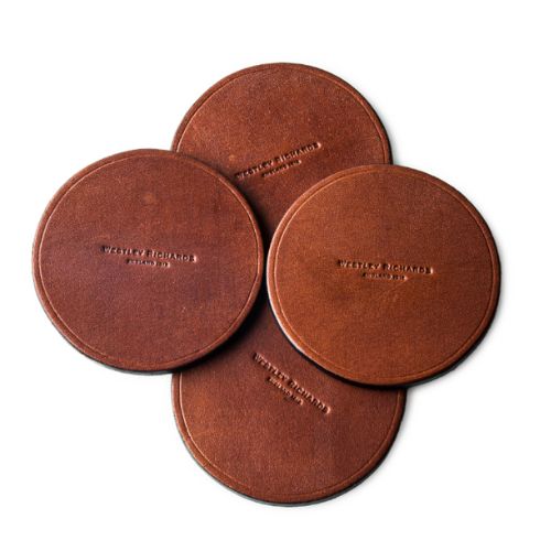 Brown leather drinks coasters with an embossed Westley Richards logo