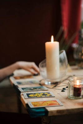 Tarot cards on table with candle | 2025 Horoscopes