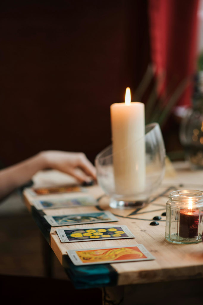 Tarot cards on table with candle | 2025 Horoscopes