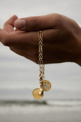 Hand holding gold locket | jewellery trends 2025