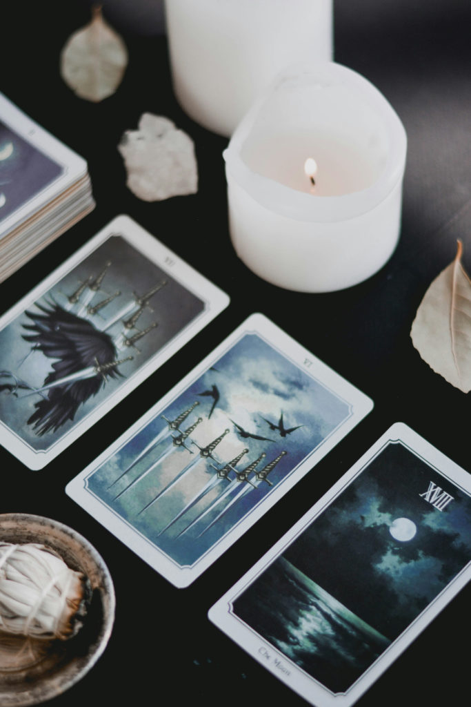 Tarot cards and candles on table | Aquarius 2025 Horoscope