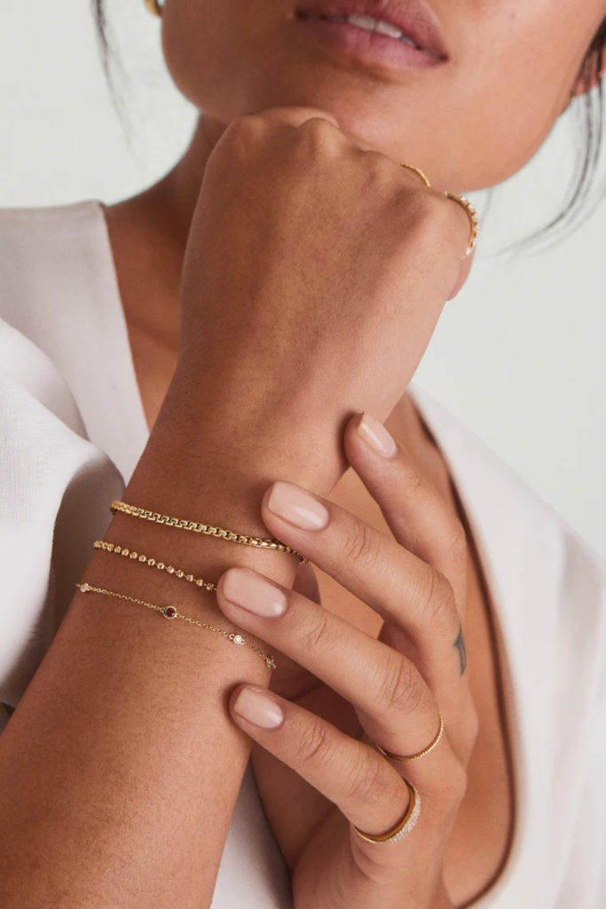 Close up of arm with Capricorn-themed jewellery